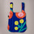 Blossom cobalt blue background with orange, yellow and green flower graphics Convertible Backpack Tote by Notabag  laying flat