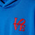 Detail of front of royal blue hooded sweatshirt featuring a small stacked 'LOVE' printed in red at upper right