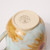 Bottom view of mug with the makers stamp on it.
