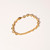 Gold-tone link style bracelet shown laying flat