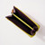 Detail of interior of gusseted zip-around wallet with yellow zipper with interior zipper