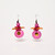 Pair of dangle earring featuring coin-shaped disks of pink with metallic gold-toned centers suspended above a series of oblong and round beads of orange and red above