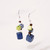 Side view of Pair of earrings consisting of a  small and tiny cubes and beads of blue and green suspended on wire