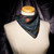 Primarily black bandana scarf tied to neck of dress form