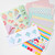 Image featuring the contents of the kit which includes instructions and paper squares.