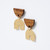 Pair of earrings with u-shaped wood top above inverted u-shaped gold-toned brushed metal base shown at angle