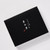 A black gift box with white Japanese calligraphy.