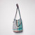 Front view of a colorful patchwork tote made of cool-toned fabrics.