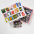 Top view of the puzzle box opened slightly to reveal the pieces inside, with a small pile of pieces below the puzzle.