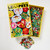 Top view of the puzzle box opened to reveal the pieces inside, with a small pile of pieces below the puzzle.