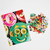 Top view of a poster with a close-up image from the completed puzzle and a small pile of puzzle pieces.