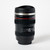Front-view of a coffee mug shaped entirely like a camera lens.