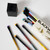 A box with vintage bird drawings opened to reveal bright gradient colors on the shafts and erasers of 12 different pencils.