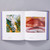 Interior spread of American Modernism: Highlights from the Philadelphia Museum of Art. The left page shows an abstract green, yellow and white painting. The right page shows a painting of a red desert landscape with the bones of an unknown creature in the foreground.