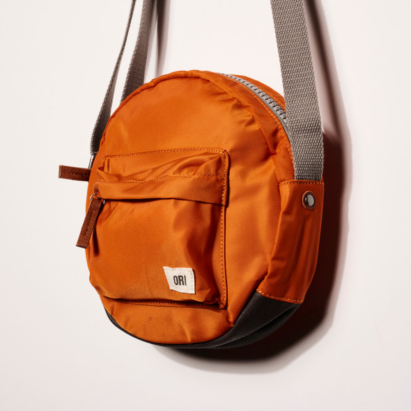 Paddington Round Nylon Crossbody Bag in Burnt Orange