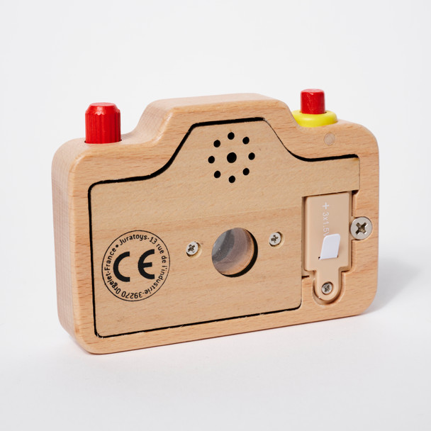 Back view of the toy camera outside of its orange carrying case