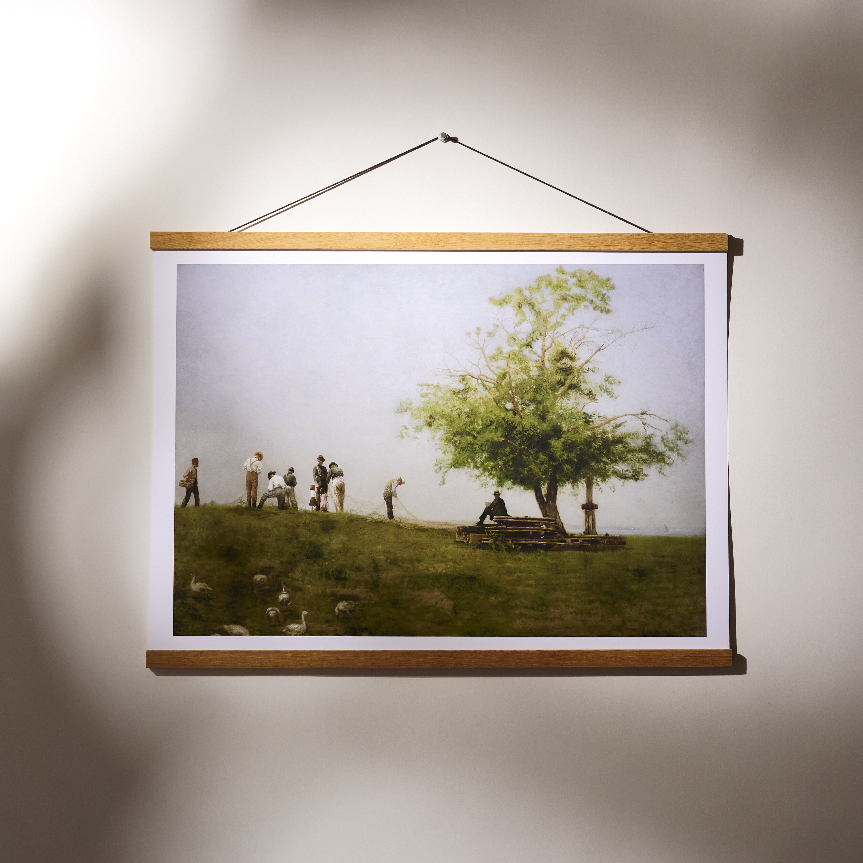 A framed landscape painting with mountains and a sunset.