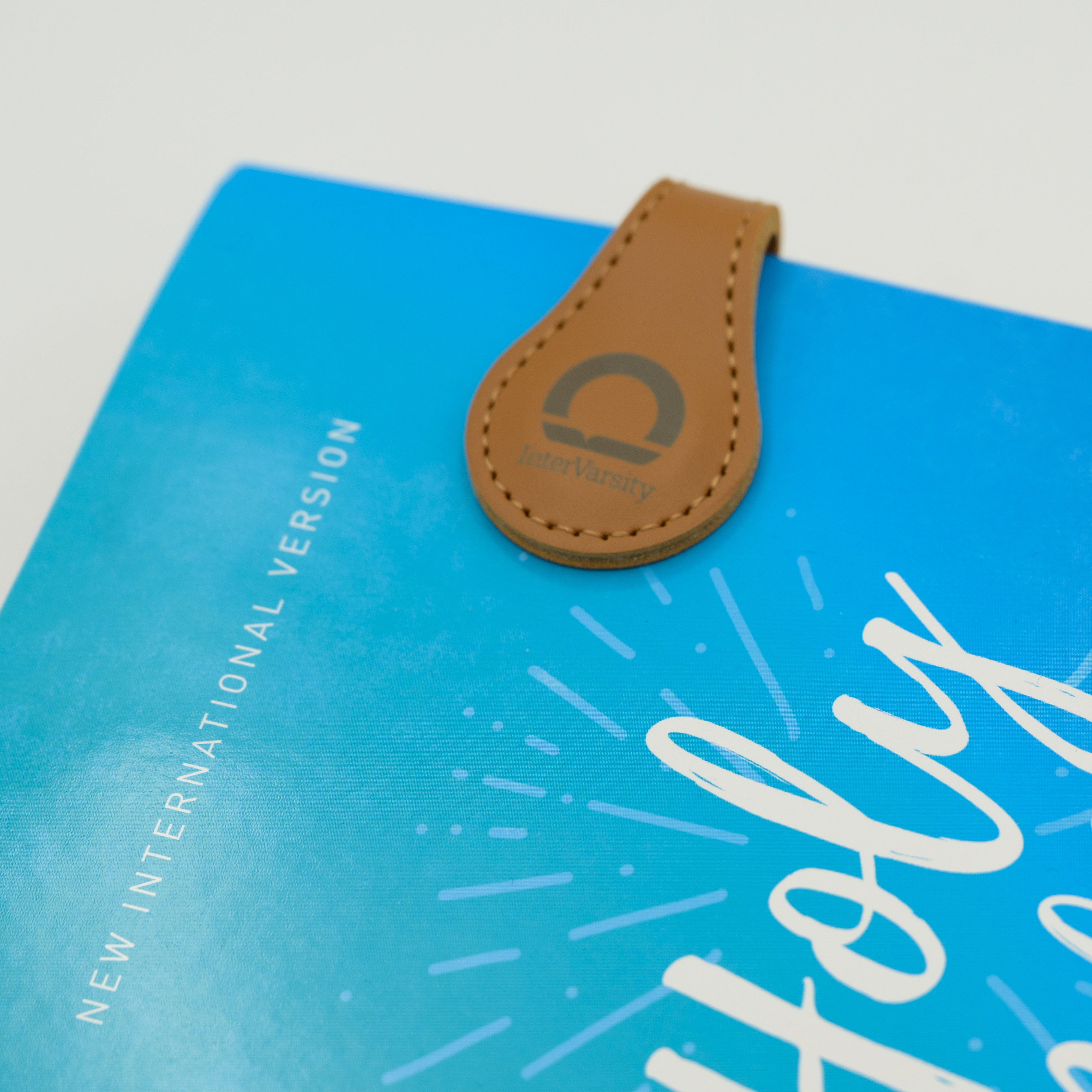 Magnetic Bookmark with InterVarsity branding.  Bookmark is faux leather material. Bible not included.