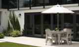 Mainstay Versatile Dining Table with a built-in umbrella sleeve