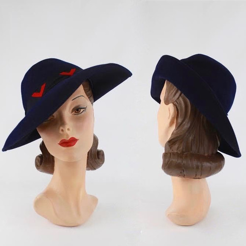 Beautiful vintage navy hat with red detail.