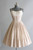 White 50's style dress with thin straps and a wide, knee-length skirt