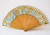 Antique hand fan in orange and blue