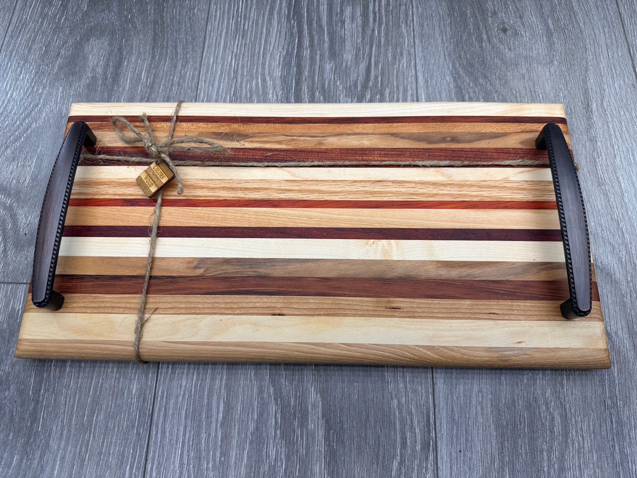 Handmade striped cutting or serving board with hanging feature