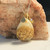 gold metallic with umbilical cord, tiny initial tag, and birthstone charm added gold metallic with umbilical cord, tiny initial tag, and birthstone charm added
