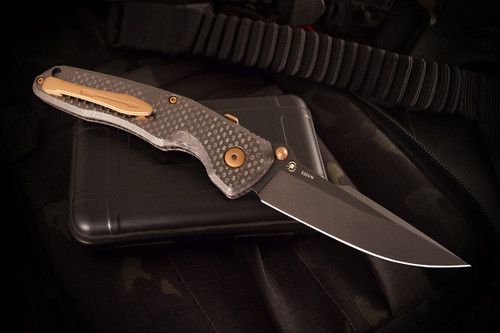Soter Carbon Fiber Edition folding knife, clip side showing black monolithic deep-carry pocket clip, black hardware, and RaceLock spine mechanism Soter Carbon Fiber Edition folding knife, clip side showing black monolithic deep-carry pocket clip, black hardware, and RaceLock spine mechanism