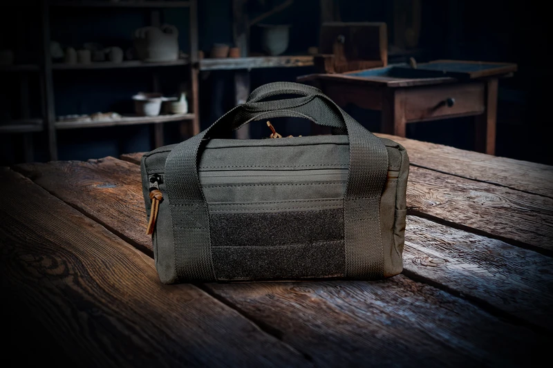 Spartan Blades Chattanooga Leatherworks waxed canvas tool bag showing rear exterior with rugged black canvas construction and zippered storage pocket.