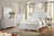 White coastal panel bed with dresser and nightstand in bright bedroom setting