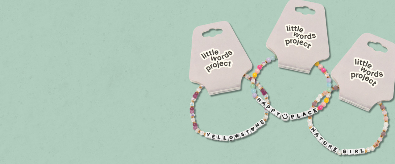 3 beaded bracelets on a tan background that say Yellowstone, Happy Place, Nature Girl.