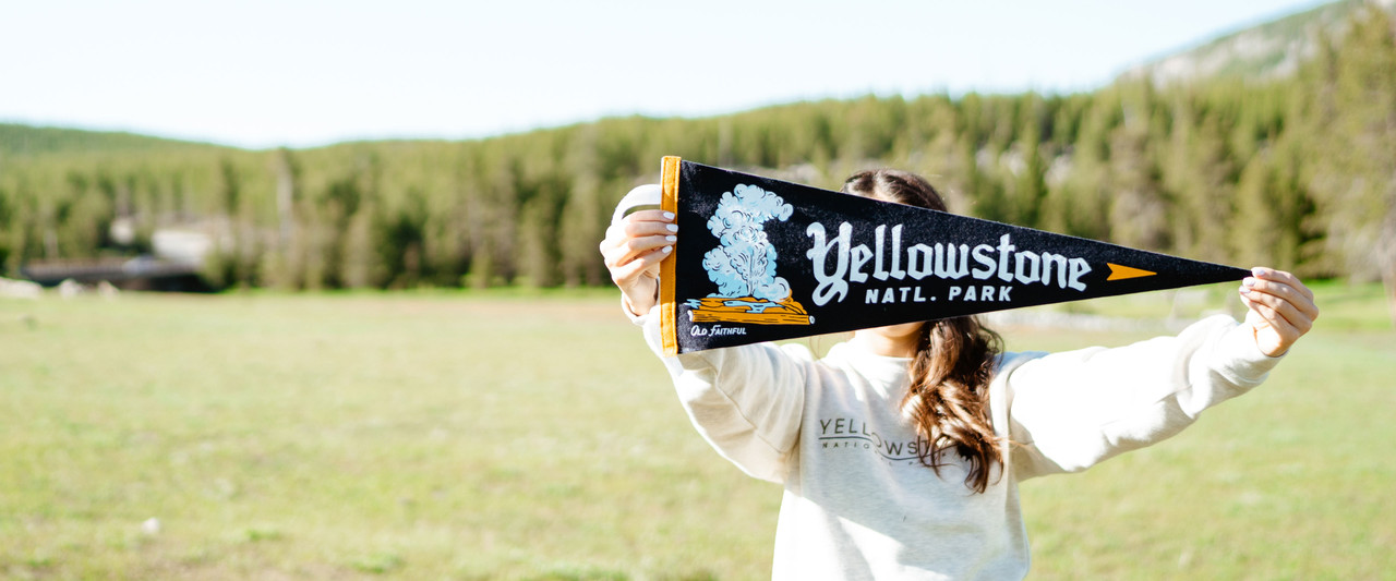 Woman holding Yellowstone National Park pennant