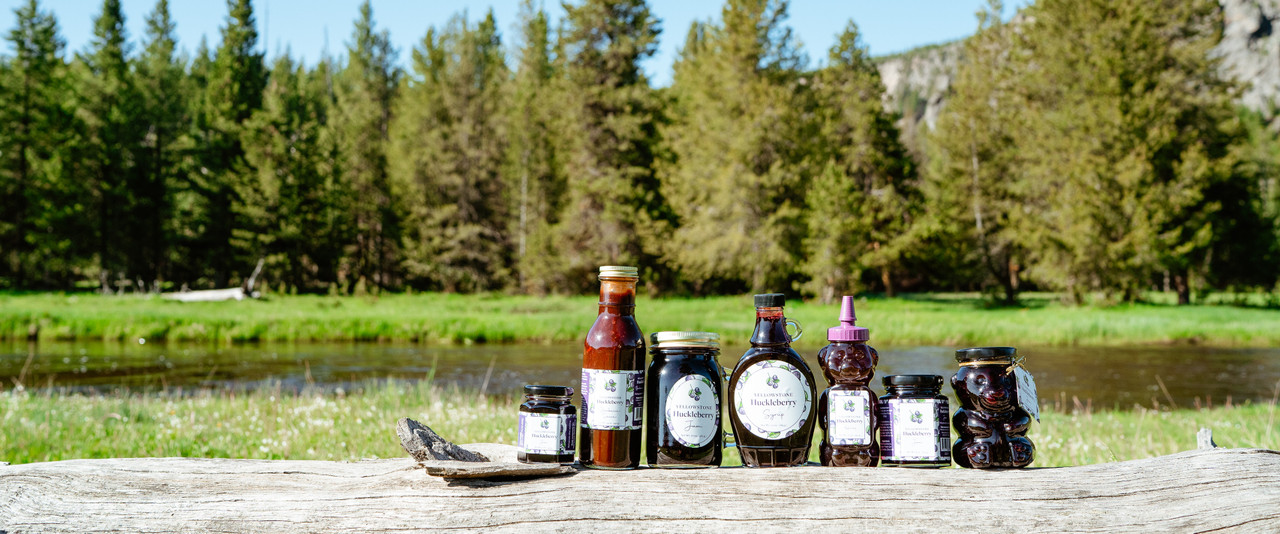 Jars of Huckleberry Products On Log At Yellowstone