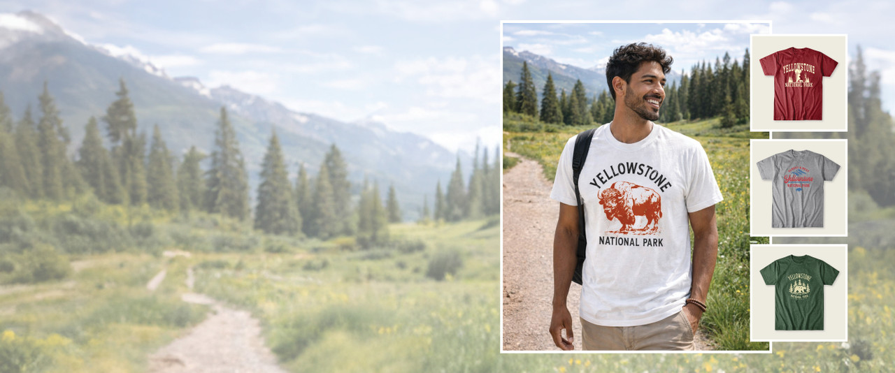 Man in Yellowstone t-shirt standing on path in front of mountains and trees in Yellowstone National Park.