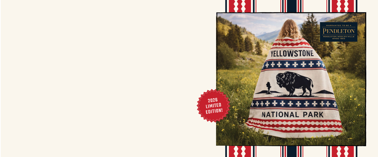 Woman wrapped in red, white, and blue Yellowstone National Park Pendleton Blanket with American Bison on it.
