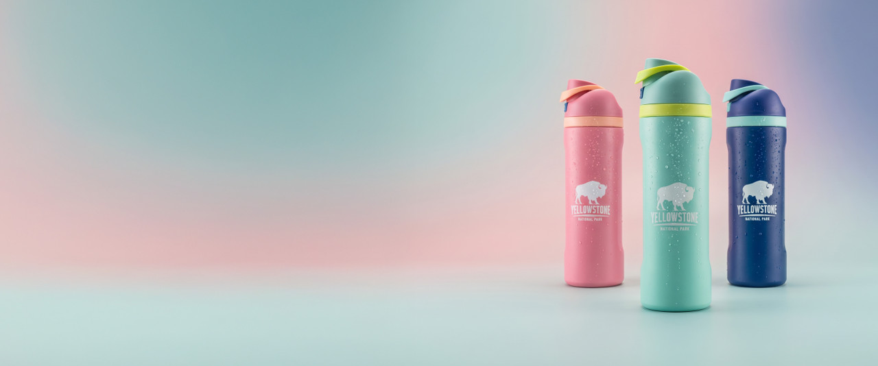 Yellowstone water bottles in pink, teal, and blue on a gradient background of the same three colors.
