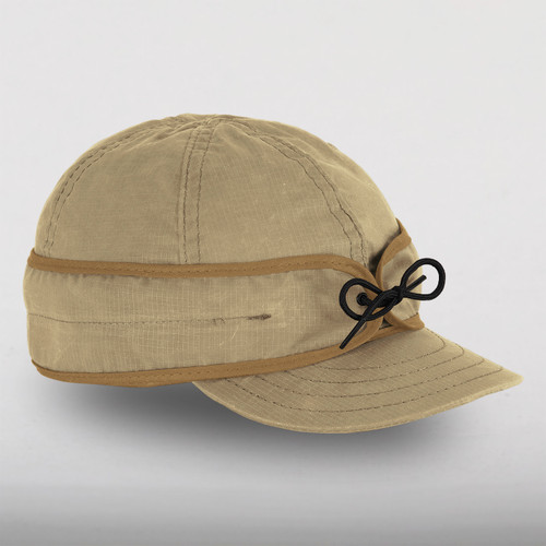 Side view of the Trail Cap - a six-paneled cap with an earband that ties in front and a brim, made with a lightweight waxed cotton.