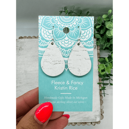 Pair of tear drop shaped earrings made of a leather backed cork which look like white birch bark