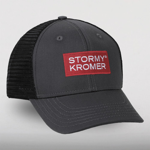Trucker cap with charcoal front and bill with a black mesh back and a red and white Stormy Kromer logo.