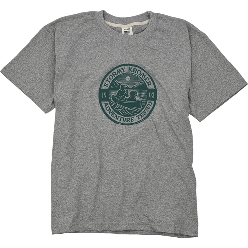 A sport gray short sleeve tee with a printed graphic of a man in a canoe with a dog in a circle stamp. A sport gray short sleeve tee with a printed graphic of a man in a canoe with a dog in a circle stamp.