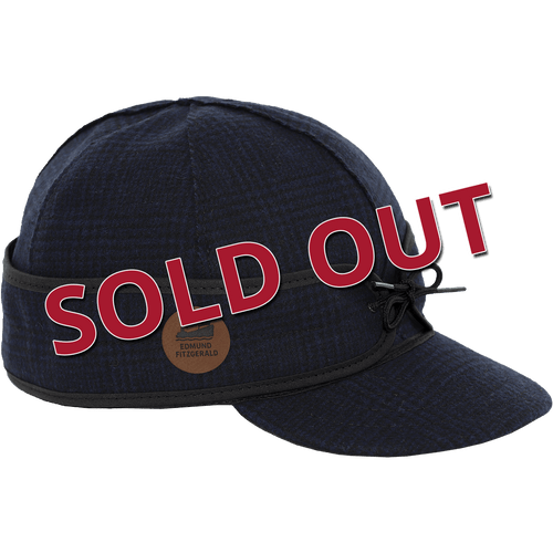 Image of a dark blue and black Original Stormy Kromer cap with the words sold out across the front of the image.