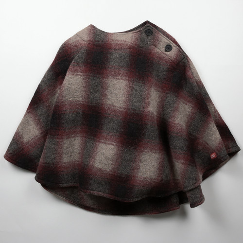 Ladies poncho in tan, red, and black plaid.