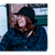 Lady smiling and wearing a black with white plaid wool cap.