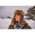 Lady in the winter wearing a charcoal gray trapper hat with faux fur long earflaps and front of hat.