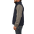 On model side view of the Ironwood Vest: A zip front wool vest with a stand collar and side pockets.