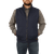 On model front view of the Ironwood Vest: A zip front wool vest with a stand collar and side pockets. Model has hands in pockets.