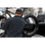 Photo from the back of a man putting his fat tire back in the back of a pick up truck. He is wearing a dark blue and green plaid Camp Shirt Jack and a wool baseball cap.
