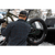 Photo from the back of a man putting his fat tire back in the back of a pick up truck. He is wearing a dark blue and green plaid Camp Shirt Jack and a wool baseball cap.
