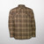 A lined, plaid flannel overshirt with snap front, two chest pockets with snap closure and two side pockets.